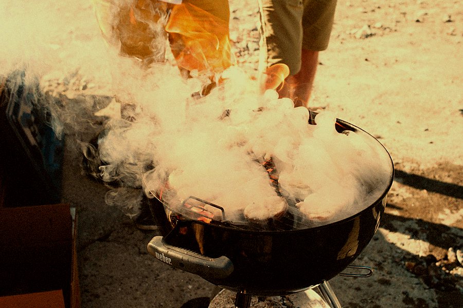 Meat smoking over a wood-fired barbecue