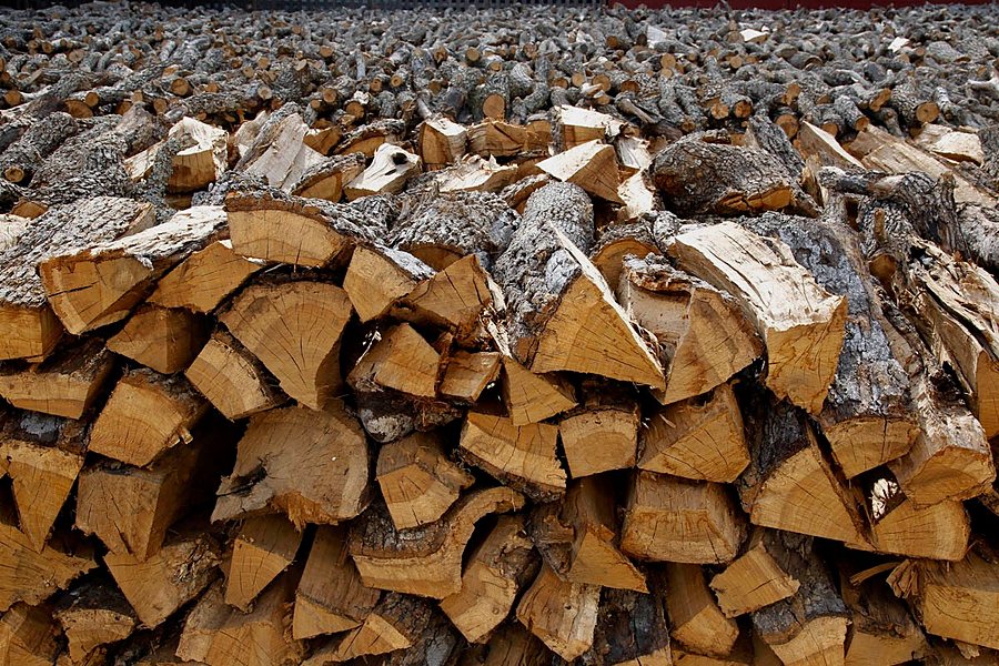 Stack of split kiln-dried firewood logs ready for delivery